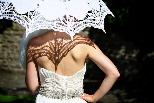 Back of bride holding parasol