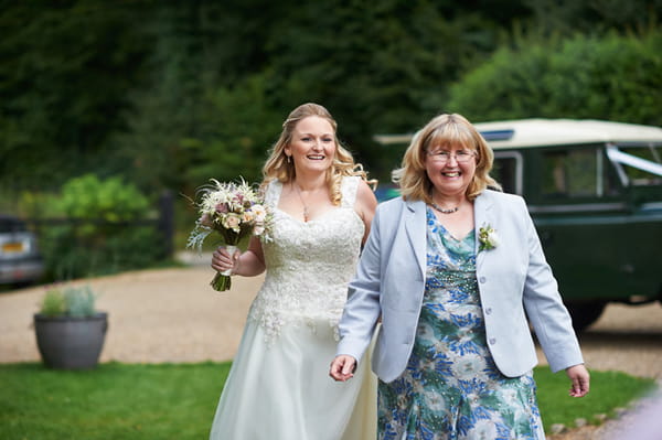 Bride walking with mother