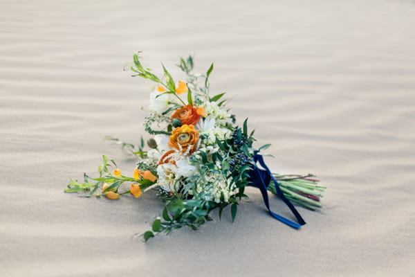 Bridal bouquet on sand in desert