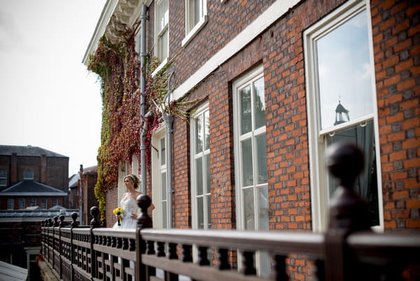 Bride standing on balcony