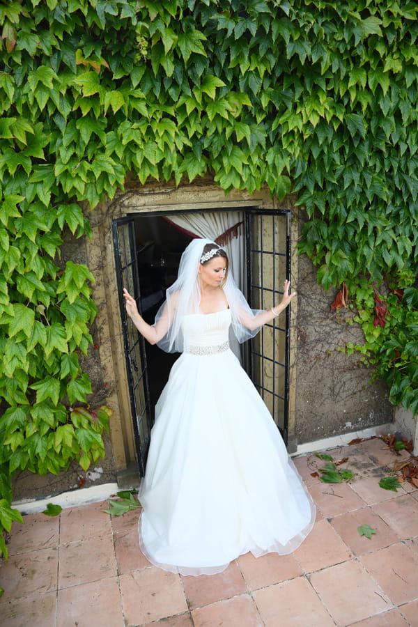 Bride standing on balcony at Walton Castle