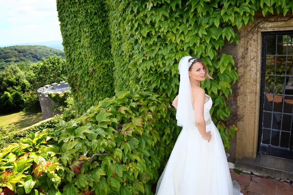 Bride standing on balcony at Walton Castle