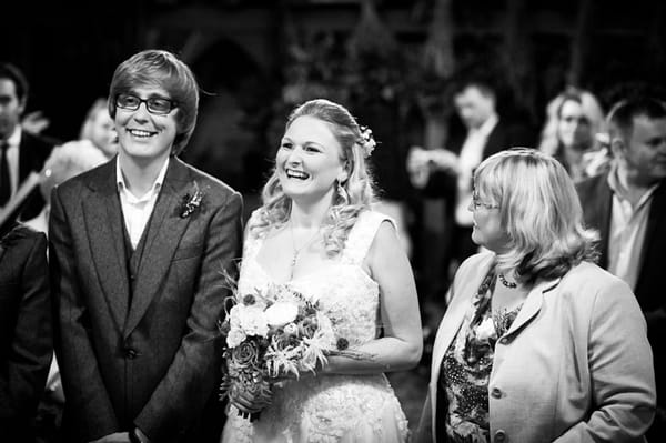 Bride and groom smiling at altar