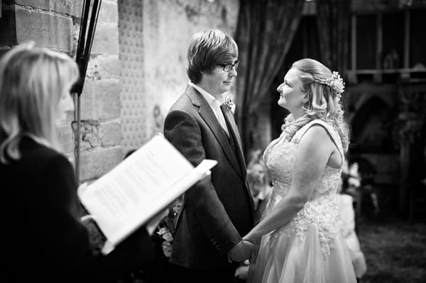 Bride and groom holding hands during wedding ceremony