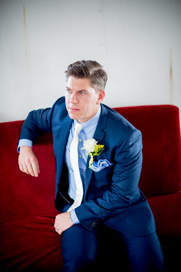 Groom sitting on couch