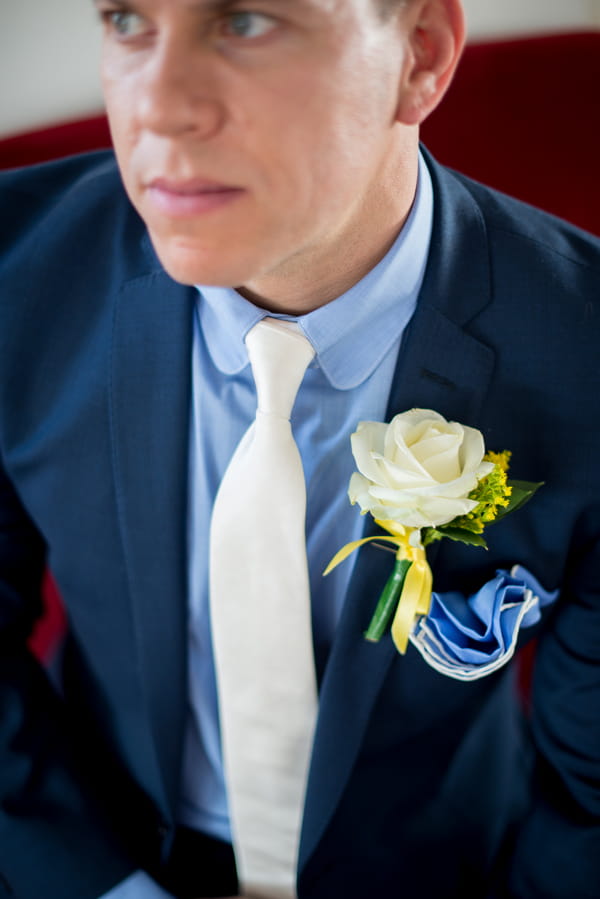 Groom's white tie and buttonhole