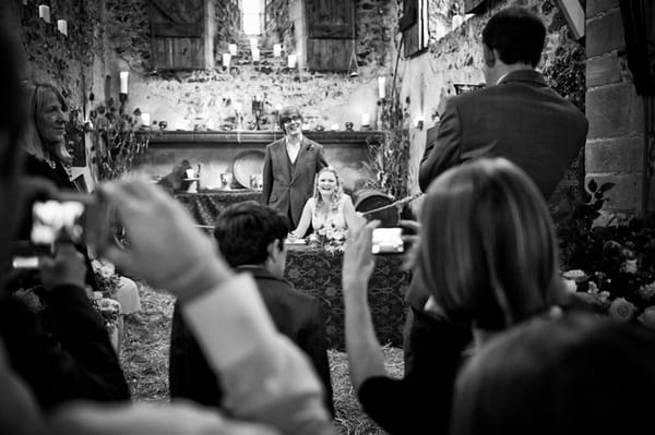 Guests taking pictures of wedding ceremony