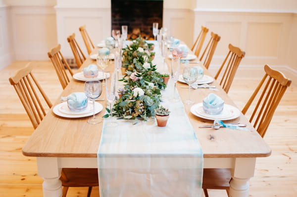Wedding table with runner and foliage centrepiece