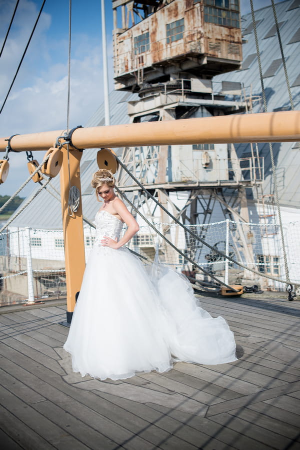 Bride on ship deck with dress dropping to ground