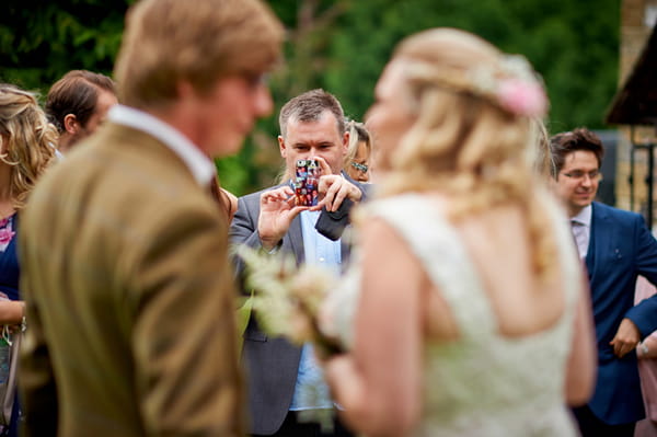 Wedding guest taking picture