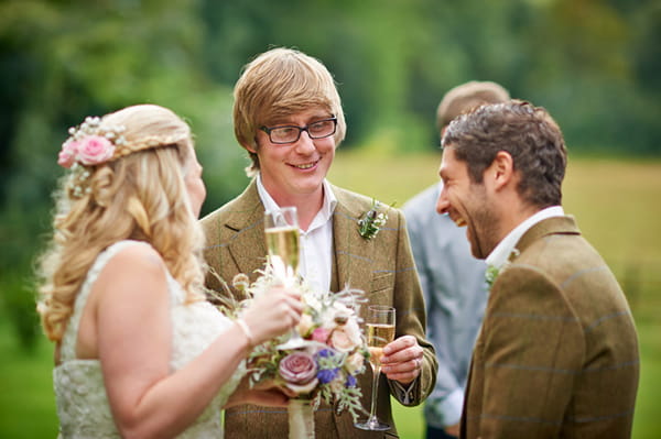 Bride and groom laughing with best man