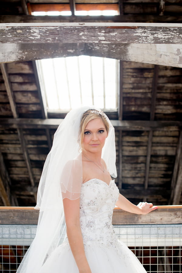 Bride leaning against beam