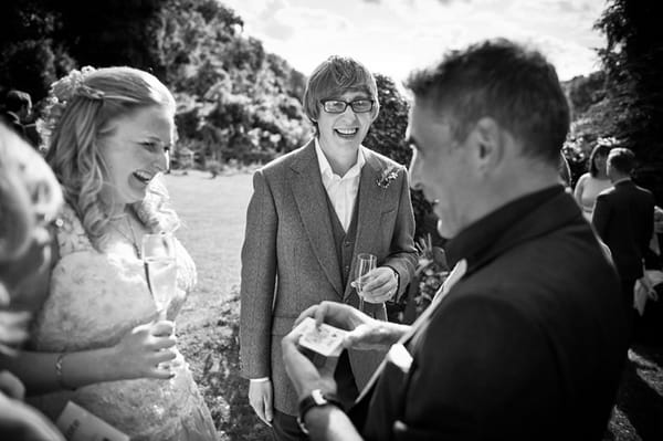 Magician showing bride and groom magic trick