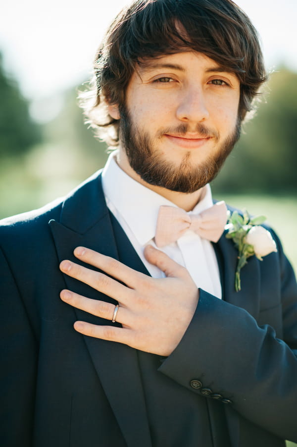 Groom with hand on chest