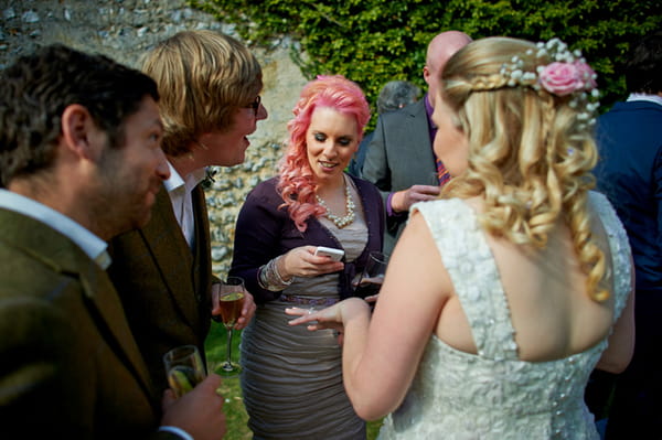 Lady with pink hair looking at phone