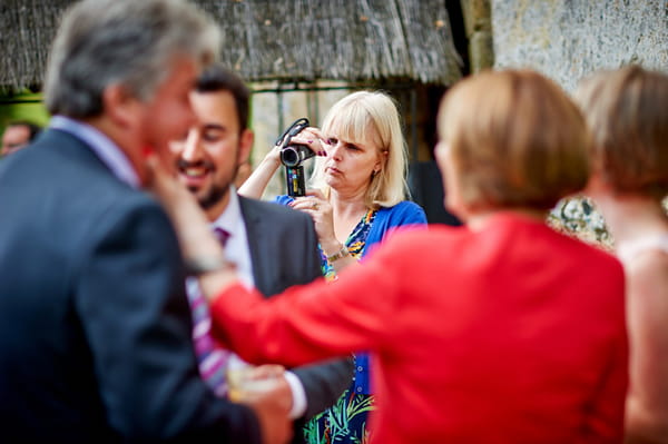 Wedding guest using video camera