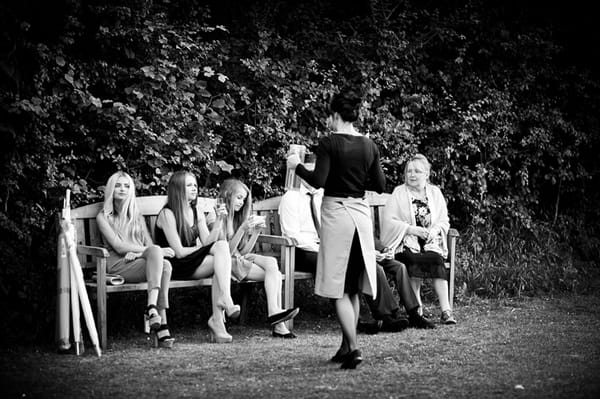 Wedding guests sitting on bench