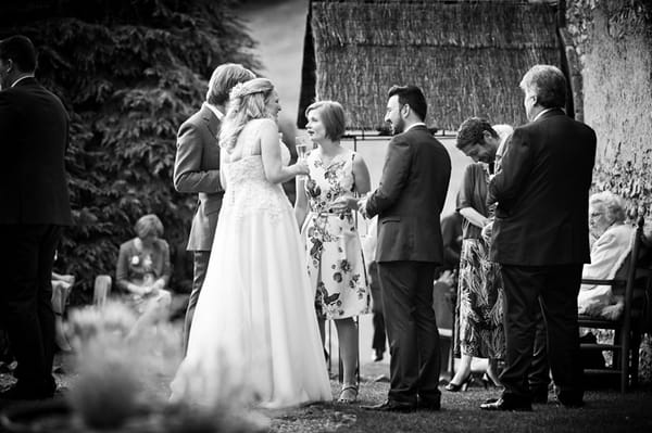 Bride and groom talking to guests