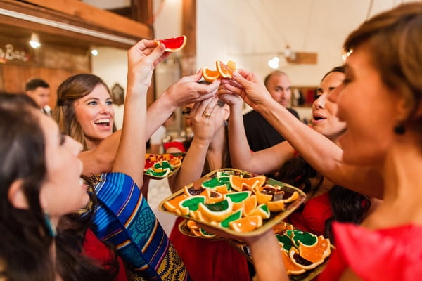 Wedding guests eating orange segments