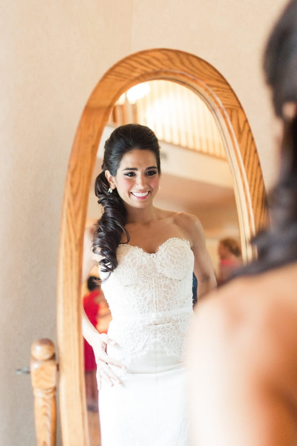 Bride looking in mirror