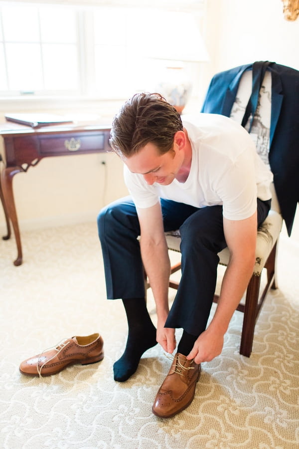 Groom putting on shoes