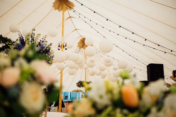 Globe lanterns hanging in PapaKata wedding tent