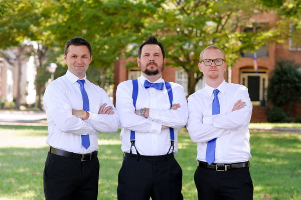 Groomsmen with blue ties and arms folded