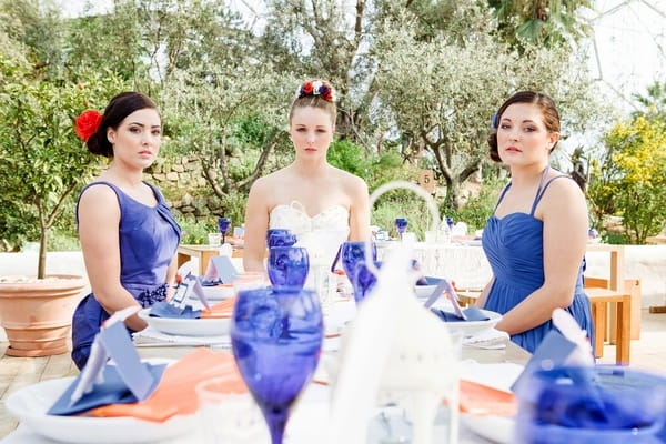 Bride and bridesmaids sitting at wedding table