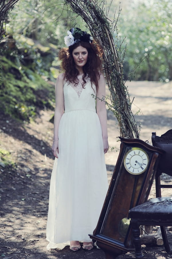 Bride standing next to grandfather clock