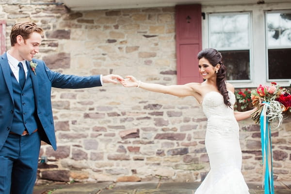 Groom holding bride's hand