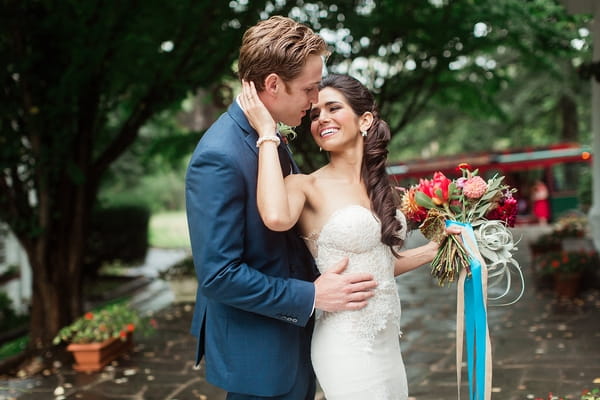 Bride with hand on groom's face