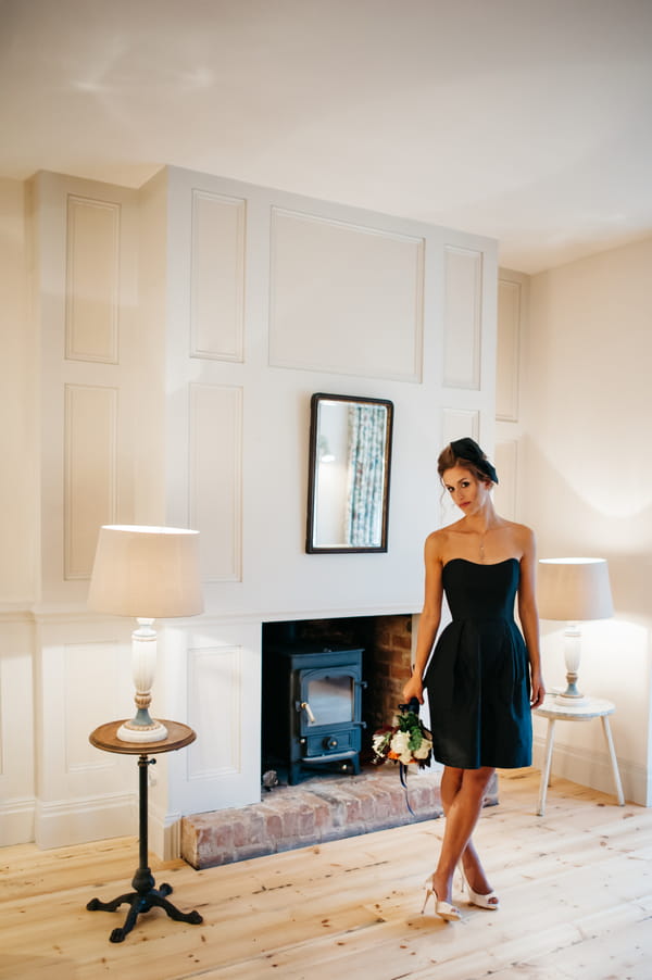 Bridesmaid in blue dress standing in room