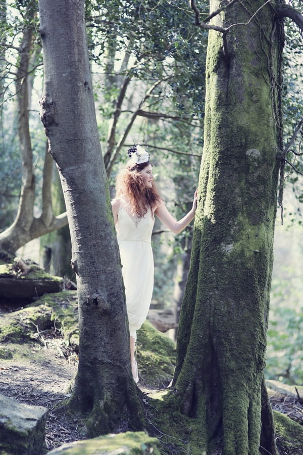 Bride standing in between trees