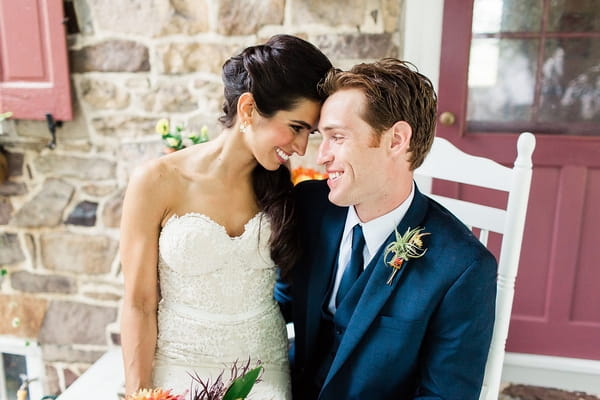 Bride sitting on groom's lap