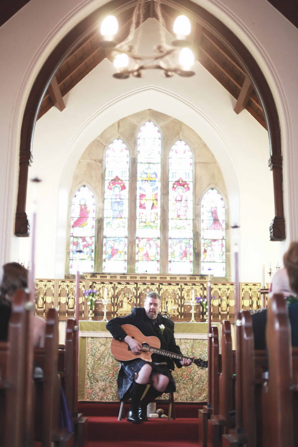 Man playing guitar in church