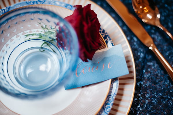 Wedding place setting with blue bowl and blue name tag