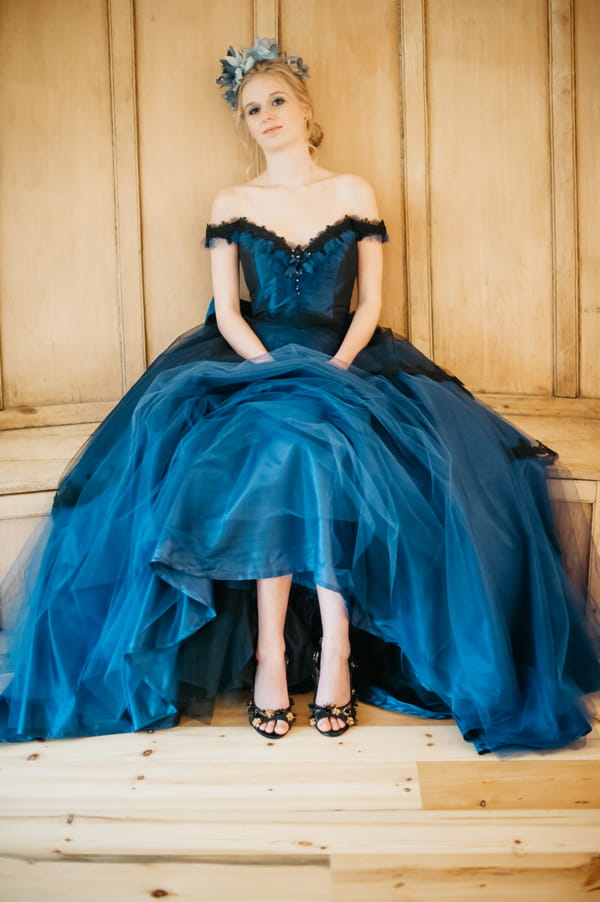 Bride with blue wedding dress sitting down