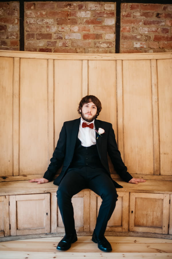 Groom sitting down