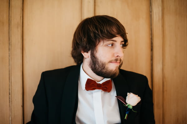 Groom wearing red bow tie