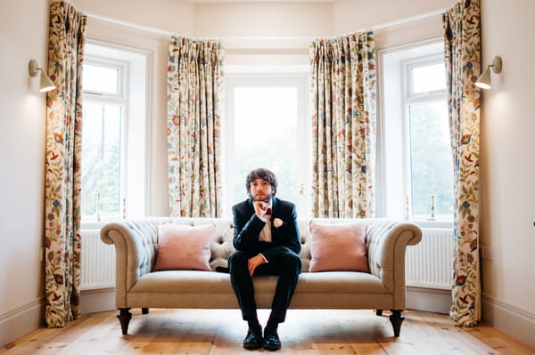 Groom sitting on sofa