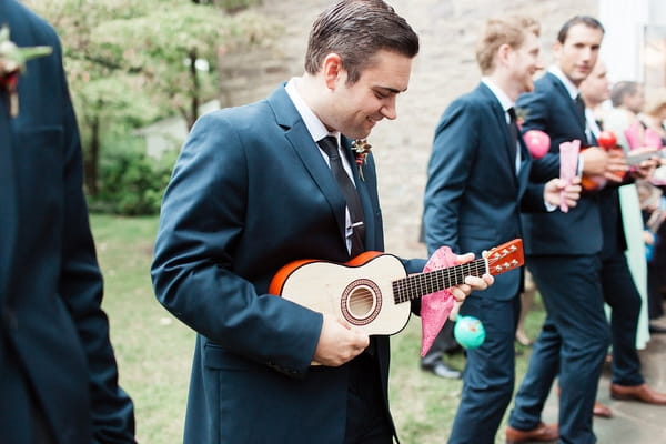 Wedding guest holding ukulele