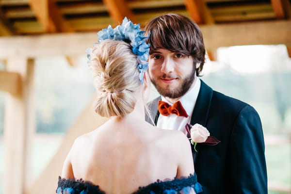 Groom looking over bride's shoulder