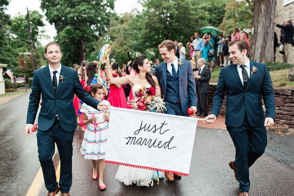 Wedding procession behind Just Married banner