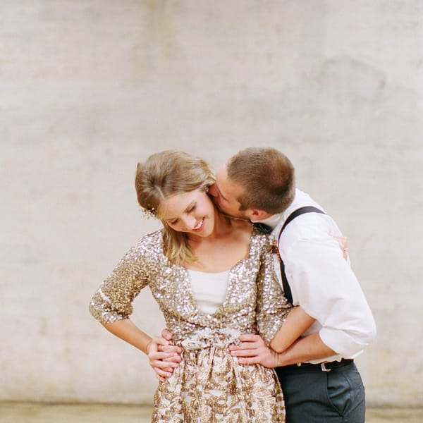 Groom kissing bride's neck