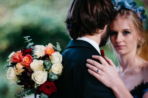 Bride with hand on groom's shoulder