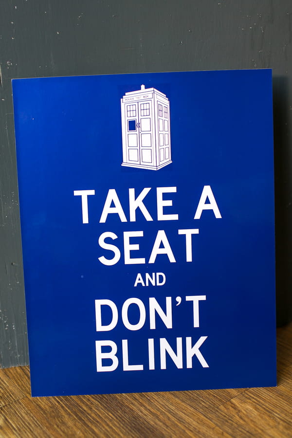 Take a seat and don't blink sign