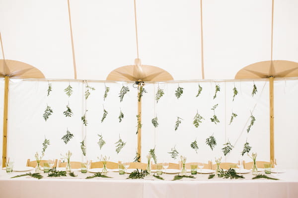 Leaf backdrop behind wedding table