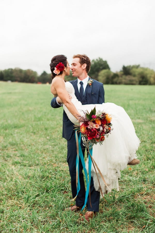 Groom carrying bride