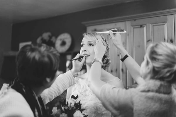 Bride having make-up done