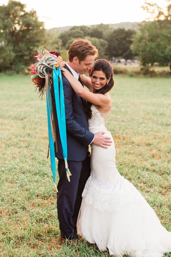 Bride with arms around groom